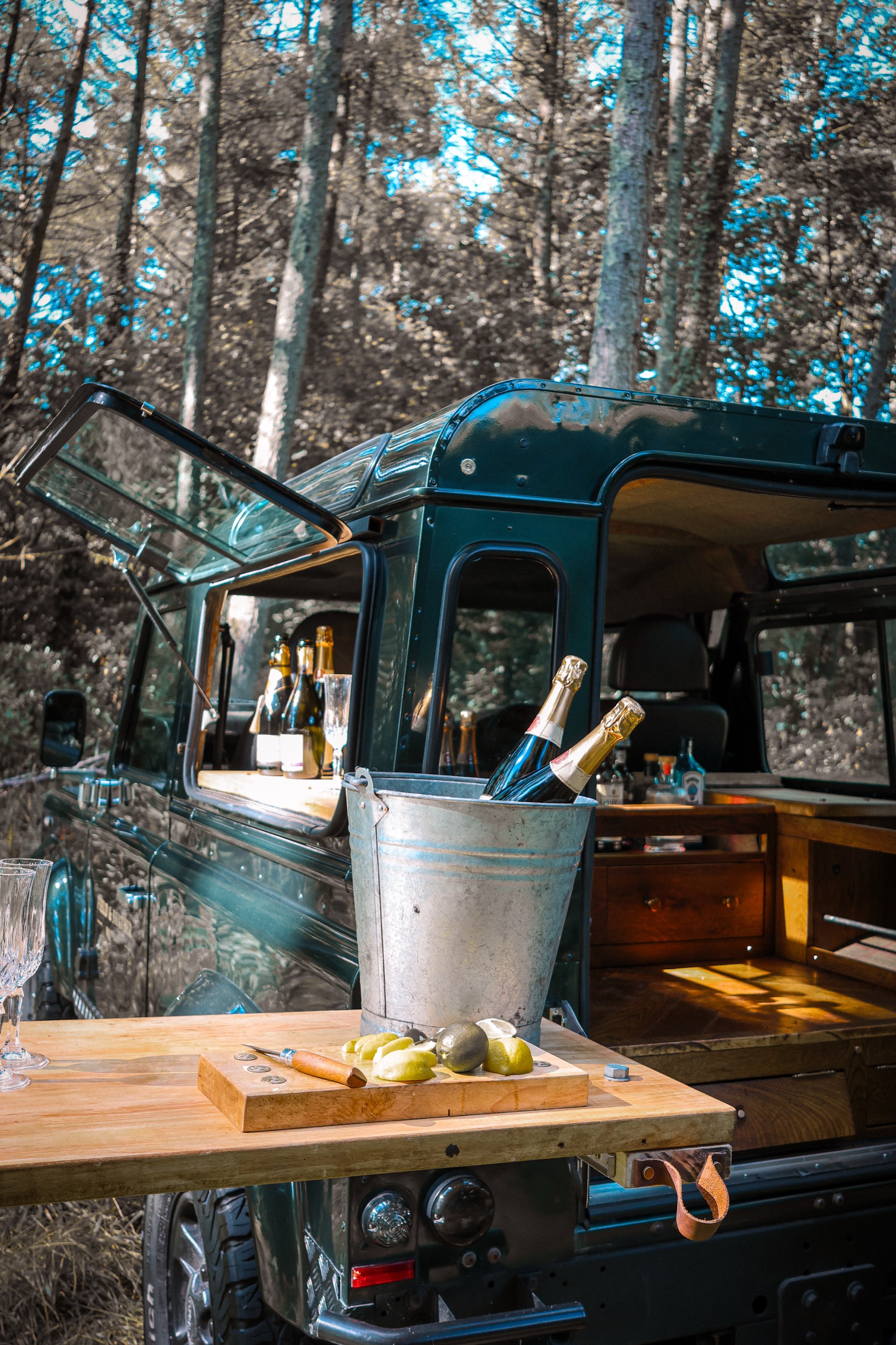 The rear hatch open onto the oak bar, with champagne on ice on the fold-down serving table